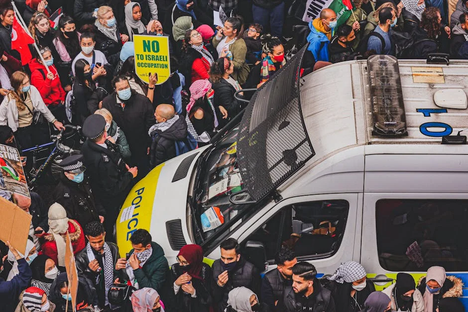 Protester Charged in Australia — Markets Watch Political Tensions — Politics Governance